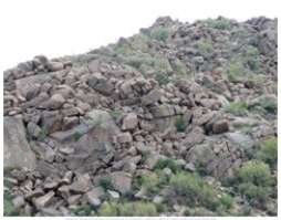 116) What type of rock likely composes the landscape shown in this photograph from the Investigation?   A) granite B) sedimentary rocks C) volcanic rocks, probably basalt D) metamorphic rocks