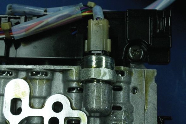 Identify the component of a 948TE transmission shown in the given figure.   A)  Reaction shaft B)  Dog clutch pressure transducer C)  Solenoid D)  E-clutch