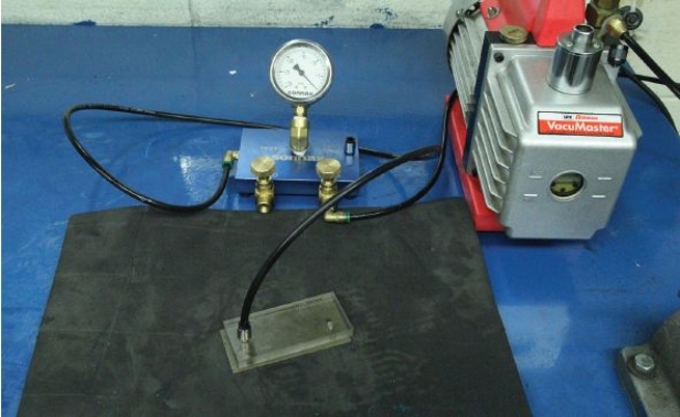 Identify the device shown in the given figure.   A)  Valve body vacuum tester B)  Lube tester C)  Air tester D)  Solvent tester
