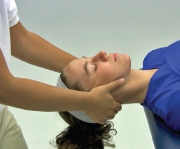 What is being performed in the following illustration?   A)  Manual cervical traction B)  Mechanical scapular traction C)  Positional cervical traction D)  Inverted cervical E)  Manual cervical traction with joint mobilization