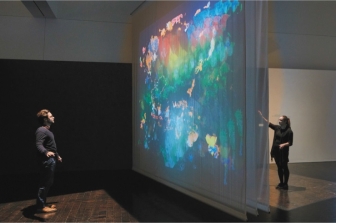   Even though Camille Utterback's Entangled (figure 6.28A)  is not a traditional painting, why might we consider it one? A)  Its message and use of paint B)  Its message and sense of human touch C)  Its incorporation of textile scrims D)  Its interaction with the audience