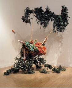   Yinka Shonibare MBE's The Swing (After Fragonard)  (figure 21.3A)  is Postmodern because it: A)  Appropriates Dutch art and rejects globalization B)  Incorporates gender themes and questions the importance of the artist C)  Is an installation that includes sculpture D)  Questions the originality of art and uses diverse media