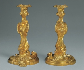   The asymmetrical, organic forms of Juste Aurèle Meissonnier's pair of candlesticks (figure 19.7)  are typical of: A)  Art Nouveau's interest in natural forms and art for everyday life B)  The Rococo's interest in decoration and playfulness C)  Romanticism's interest in drama and movement D)  Neoclassicism's interest in looking backward and convention