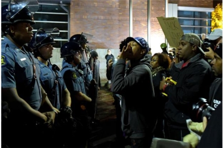   -This image of protestors confronting police is from one of the largest series of Black Lives Matter demonstrations, after the death of _______ in Ferguson, Missouri A)  Eric Garner B)  Michael Brown C)  Trayvon Martin D)  George Floyd