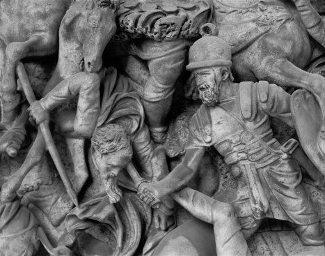   Which Germanic military custom does this bas-relief depict? A)  The reliance on iron armor B)  The use of cavalry C)  The preference for double-edged swords D)  The adoption of Roman fighting techniques