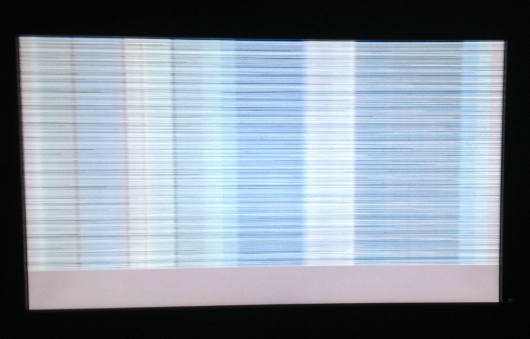 This is a picture of a monitor that has a horizontally torn image. What is the most common cause of a monitor showing horizontally torn images on the screen?   A)  Video cable not properly seated. B)  Refresh rate out of specification. C)  Not enough video memory. D)  GPU on video card overheating.