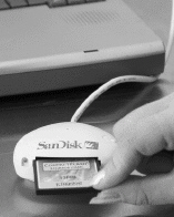   In the figure shown above, a memory card is being inserted into a ____. A) USB port B) docking station C) card reader D) FireWire port