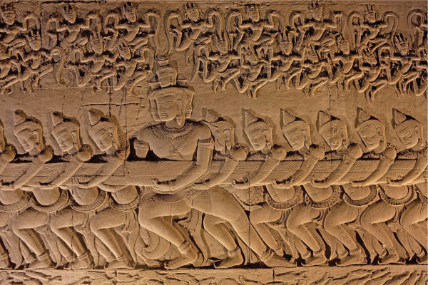 ​   How is rhythm deployed in Churning the Ocean of Milk from Angkor Wat? A) The heads are rendered with syncopated rhythm. B) The demons are depicted with alternating rhythm. C) The spirits in the top section are represented using eccentric rhythm. D) The series of legs is depicted using regular rhythm.