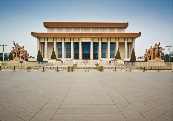 ​   How is the placement of the Mausoleum of Mao Zedong significant? A) The mausoleum is placed above the imperial tombs to mark Communism's victory over its predecessors. B) The mausoleum is situated in Beijing's traditional core to assert the authority of the Communist government after centuries of imperial rule. C) It is placed on the holy mountain outside of Beijing as a mark of the prestige of the Communist leader. D) Its placement aligns with sunrise on summer solstice to mark the dawning of a new era for China.