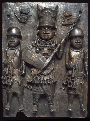 ​   Which statement about the Plaque with Warrior and Attendants is correct? A) This image marked the gateway to the palace watch tower. B) This was one of the many brass plaques that adorned the Benin palaces. C) Much like the Palette of King Narmer , it celebrated the unification of two states. D) The shine of the brass symbolized the rays of the sun.
