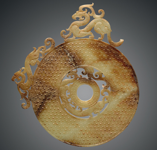 ​   What material makes up this Chinese bi disk with dragon? A)  Ceramic B)  Bronze C)  Jade D)  Sandstone