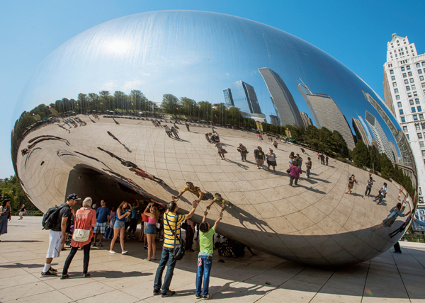 <strong> Anish Kapoor's Cloud Gate is most similar to Richard Serra's Tilted Arc in what respect?</strong> A) Its arch form that allows people to walk under it B) Its location in a plaza in a busy city C) Its reflective, mirrorlike surface D) The public's reaction to the work