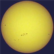 <strong>The figure shows the Sun and pairs of sunspots. One could say that there is really a 22-year sunspot cycle because </strong> A) the time between sunspot number maxima is 22 years. B) the time between maxima of the same magnetic polarity of sunspot pairs is 22 years. C) it takes sunspots 22 years to move from the poles to the equator. D) at maximum there are 22 sunspots per year.